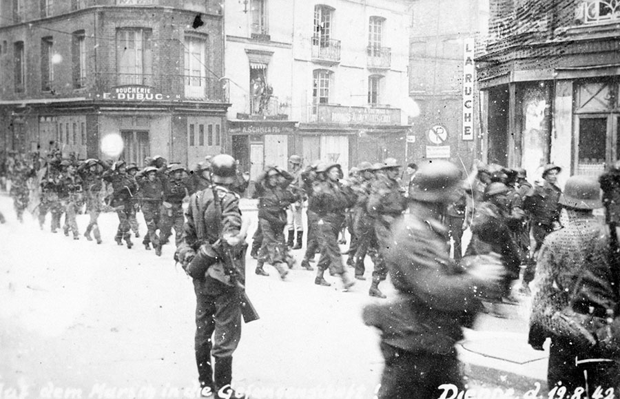 Captured Canadian troops are marched through the streets of Dieppe, following Operation Jubilee
