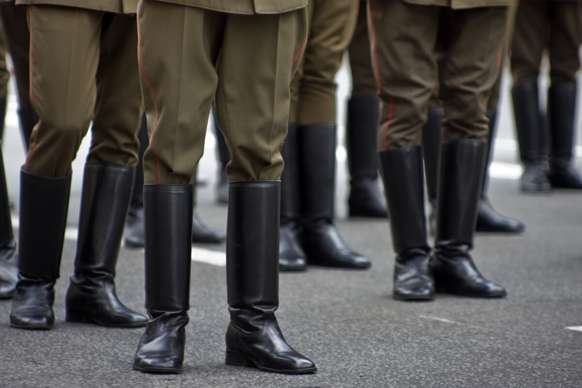 A photo shows a group of legs in military khaki pants and boots