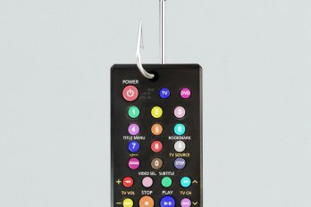 A TV remote control with rainbow buttons.