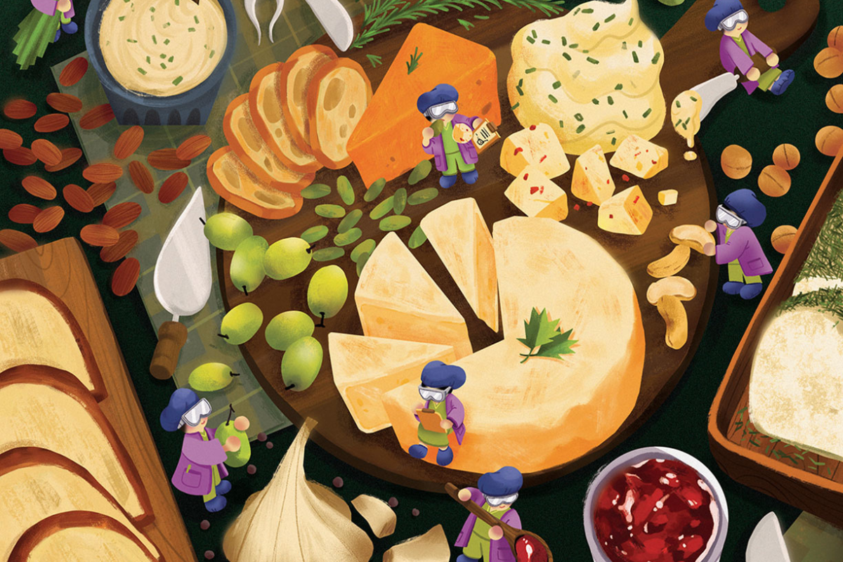 An illustration of a charcuterie board and table loaded with cheeses, garlic, grapes and olives. Tiny goggle-wearing scientists take notes and inspect foods.